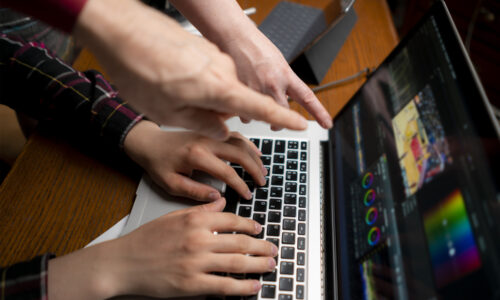 friendly team making movie using a laptop, videoediting process